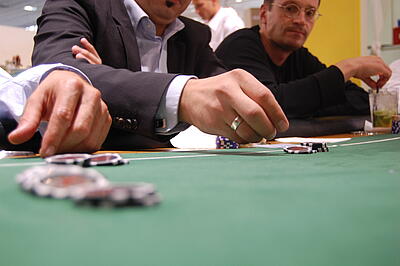 Poker-Tisch als Idee für den Messestand Gäste machen ihre Einsätze beim Pokern